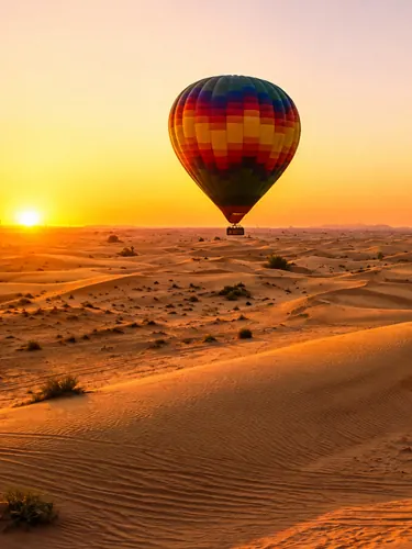Golden desert dunes in Dubai viewed from a hot air balloon