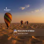 Hot air balloons preparing for takeoff over the Dubai desert at sunrise.