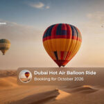 Hot air balloon floating above the Dubai desert during an October sunrise.