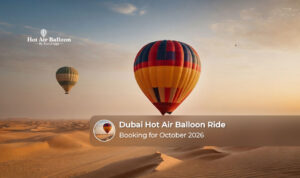 Hot air balloon floating above the Dubai desert during an October sunrise.