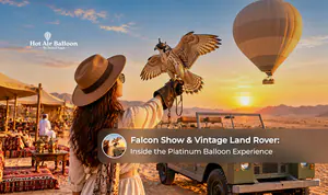 Falconry performance beside a vintage Land Rover during a premium desert balloon experience in Dubai.